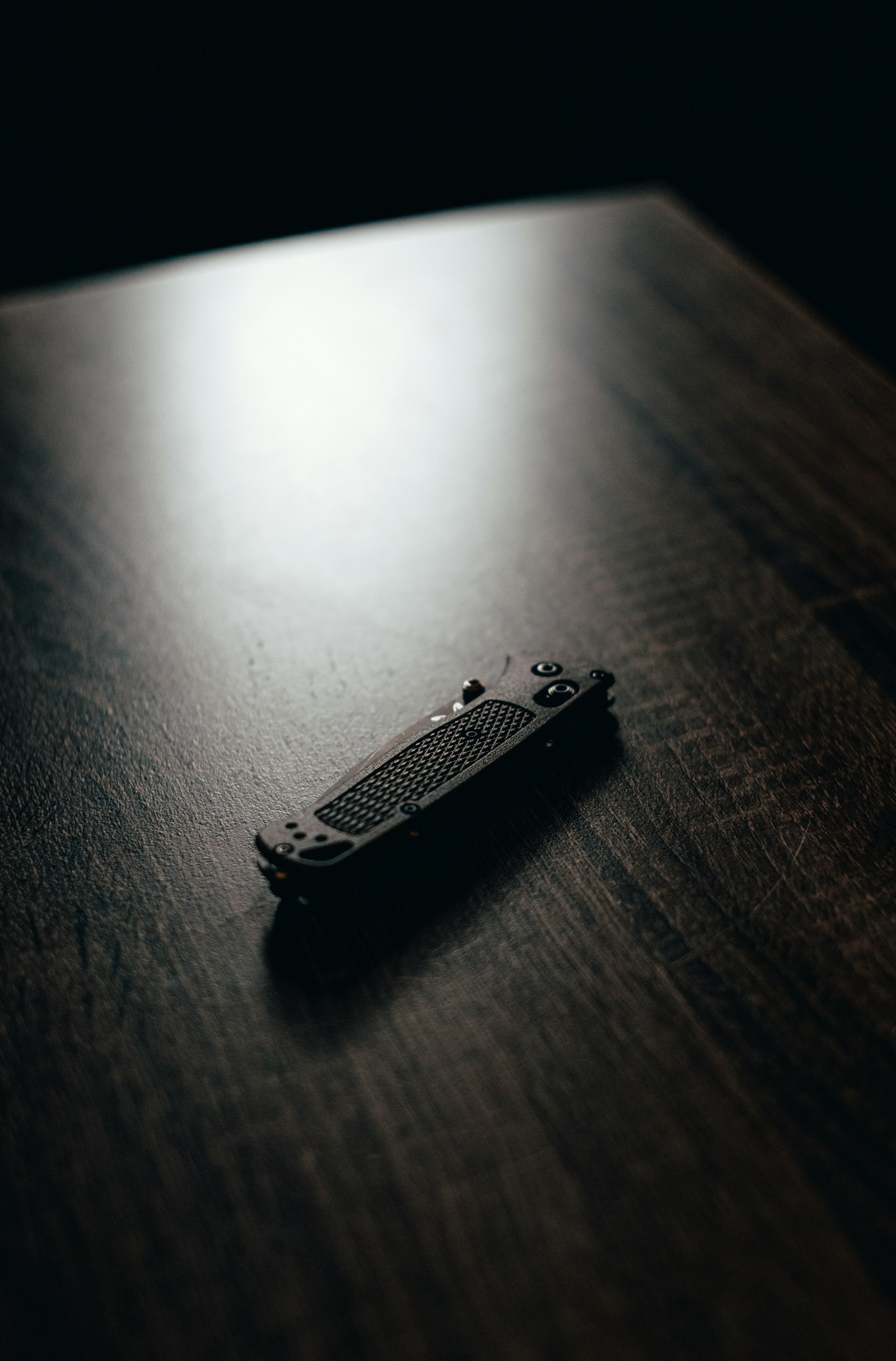 PLUME ARC slim device in a shaft of light