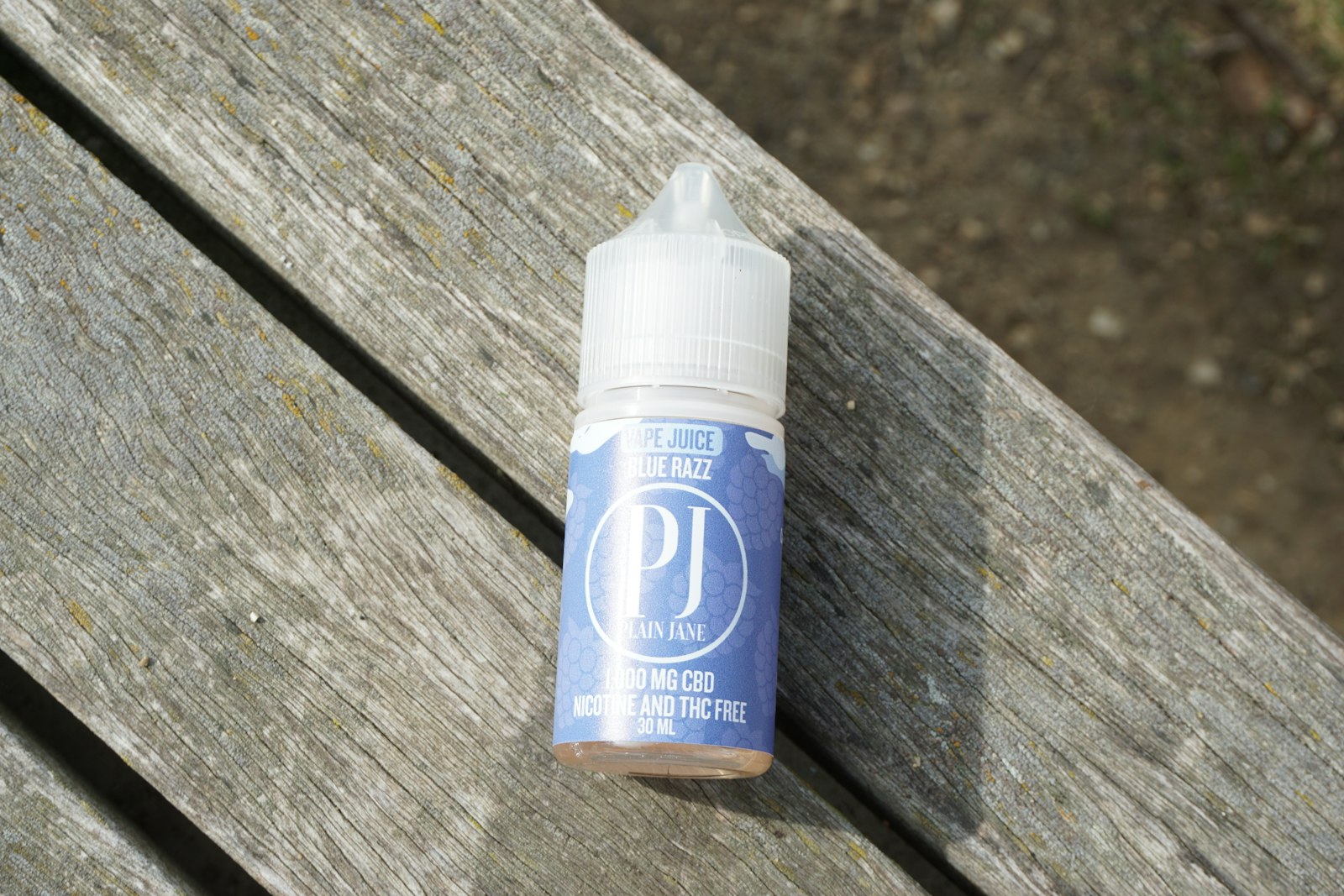 PLUME RESERVE bottle on dark wood